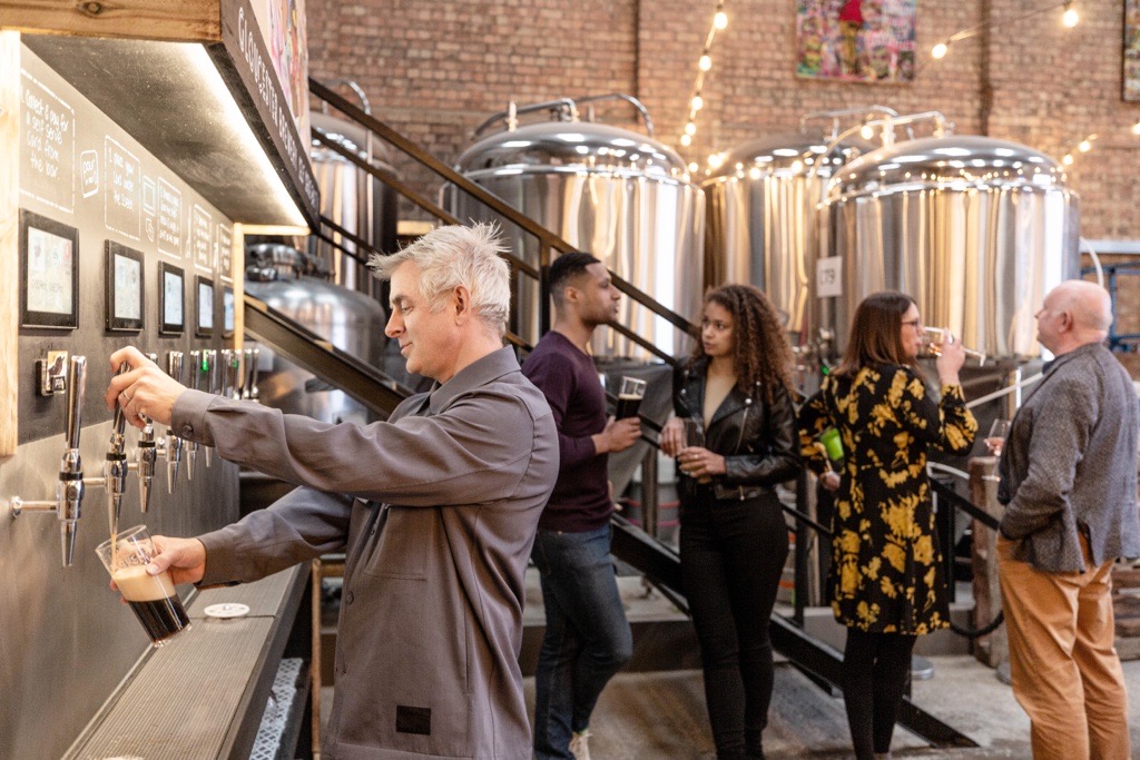 Man pouring a beer from the Tap at Gloucester Brewery